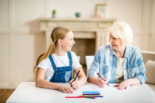 Girl with grandmother drawing — Stock Photo, Image