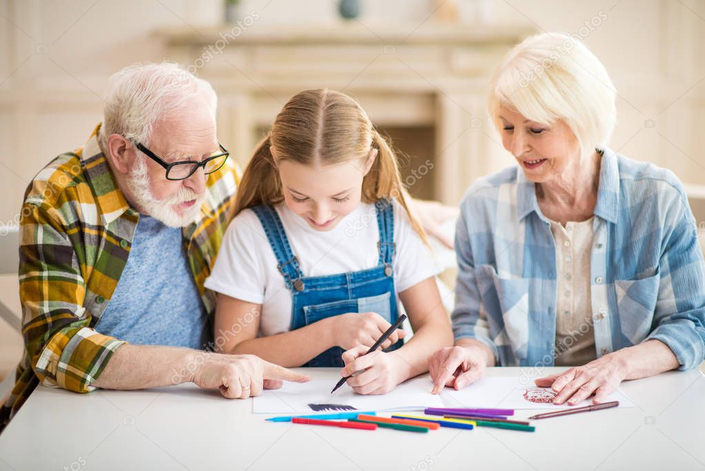 Girl with grandparents drawing