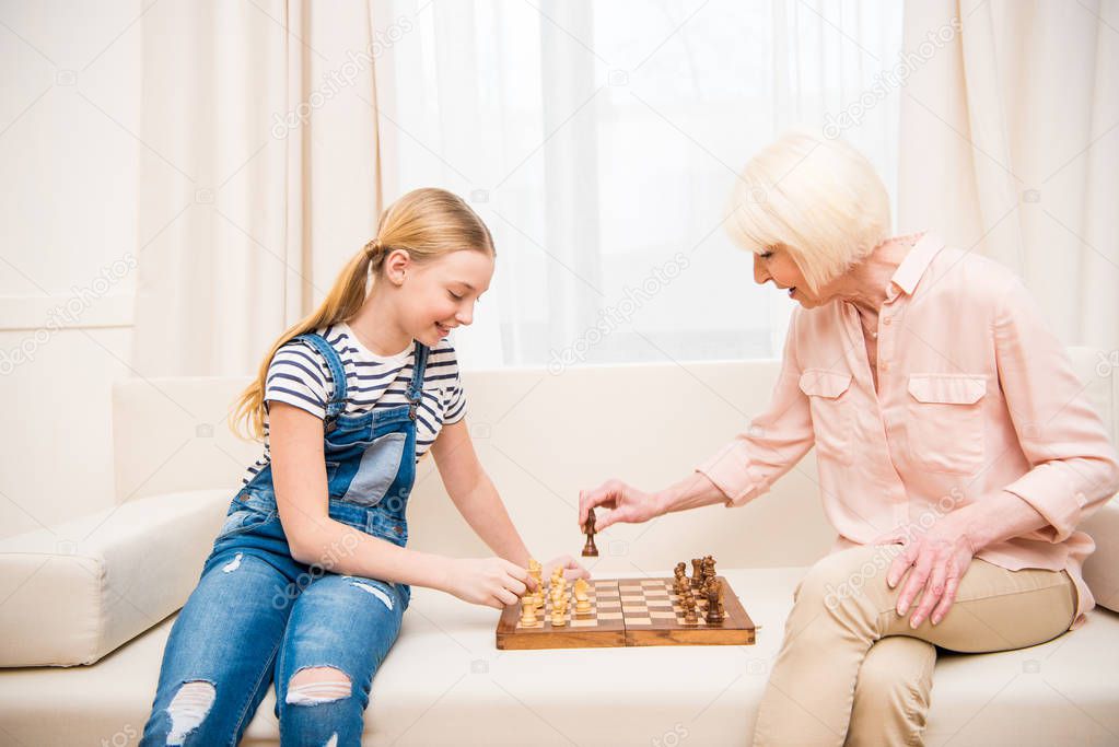 Grandmother and granddaughter playing chess