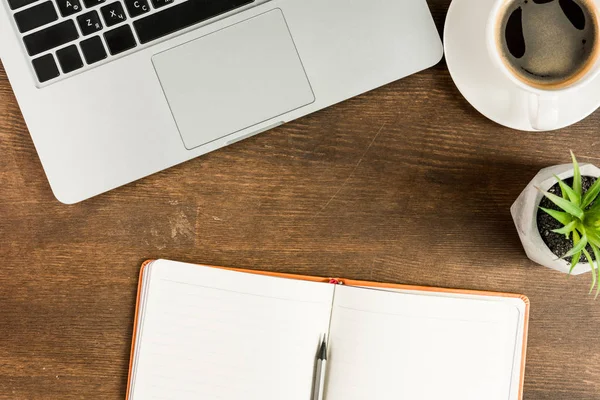 Laptop and notebook at workplace — Stock Photo, Image