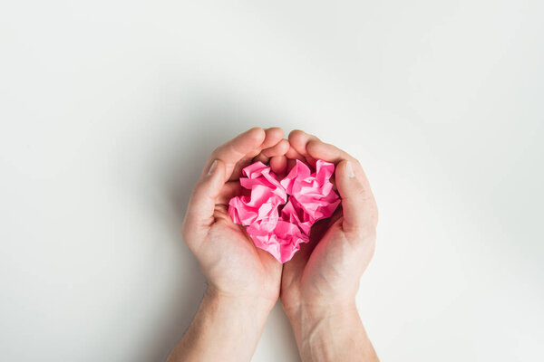 hands holding wrinkled papers
