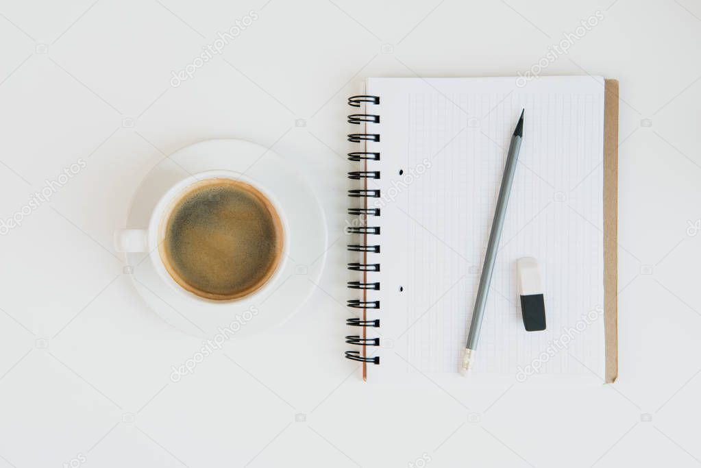 notebook with pencil and cup of coffee