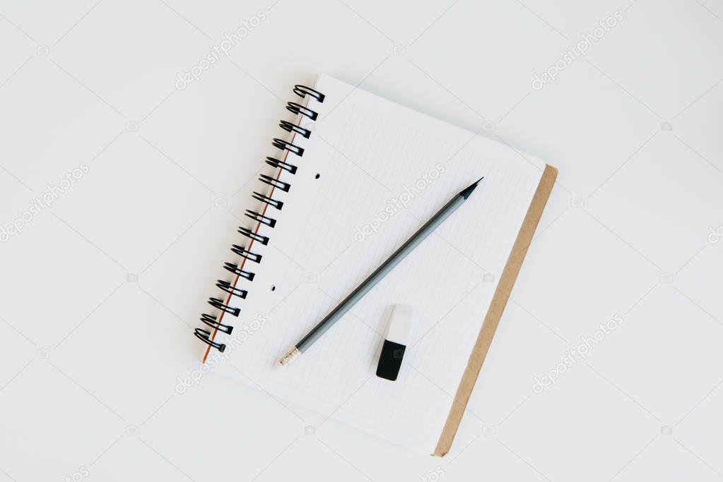 notebook with pencil and rubber