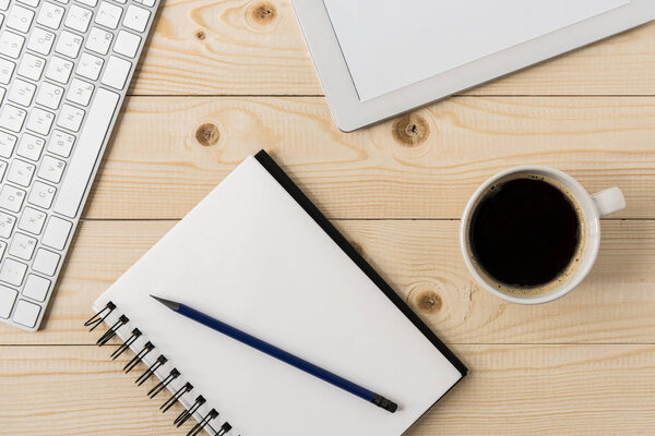notebook with cup of coffee and digital tablet