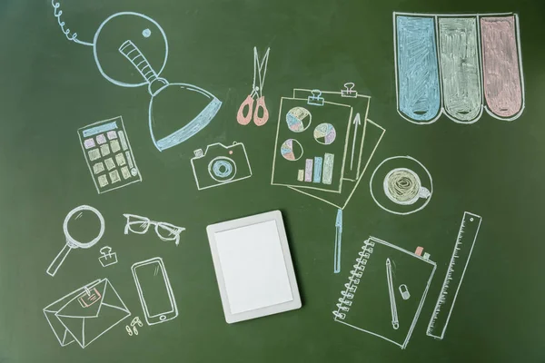 Tablet and pictures on green board — Stock Photo, Image