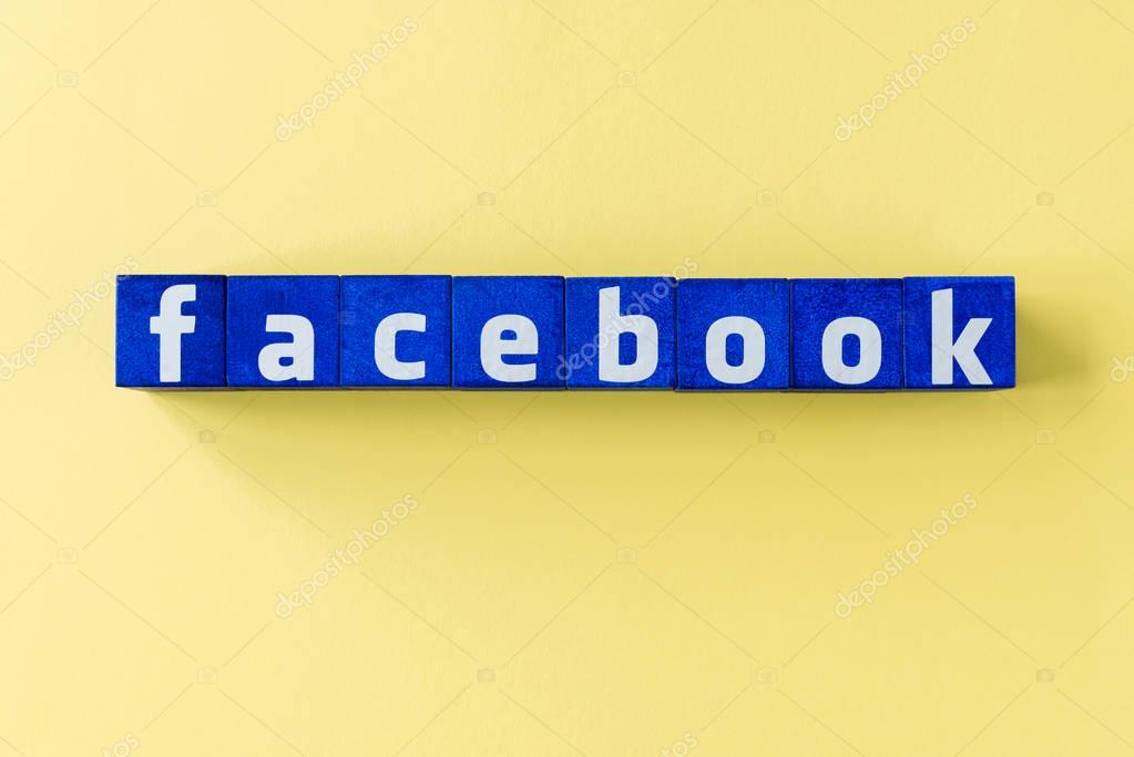 Word Facebook made from blue cubes on yellow surface