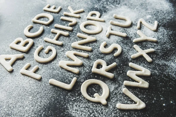 Dough for cookies in forms of letters — Stock Photo, Image