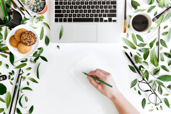 Laptop and person at workplace 