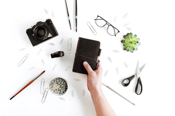 Human hand and office supplies — Stock Photo, Image