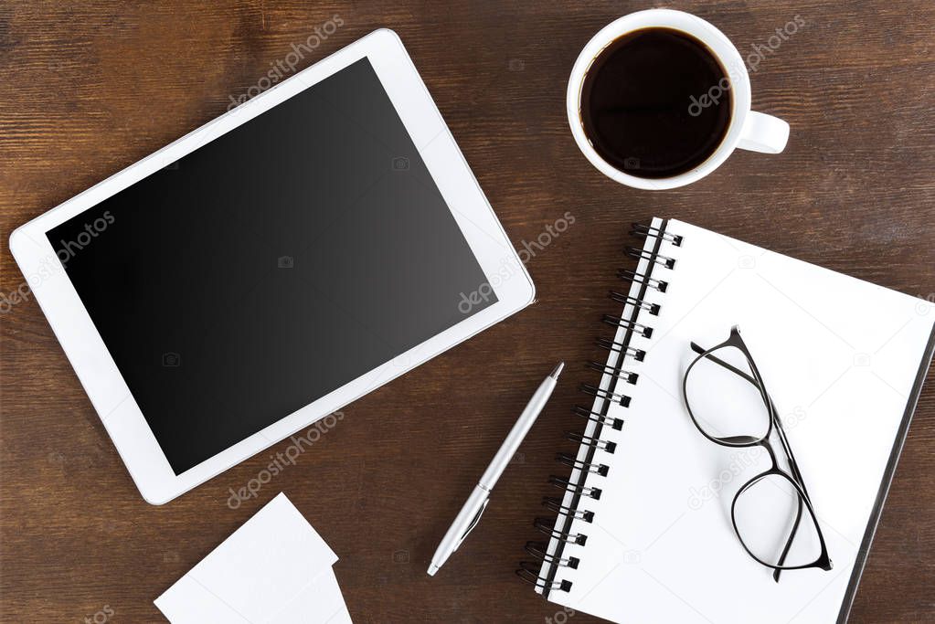 coffee cup and tablet on workplace