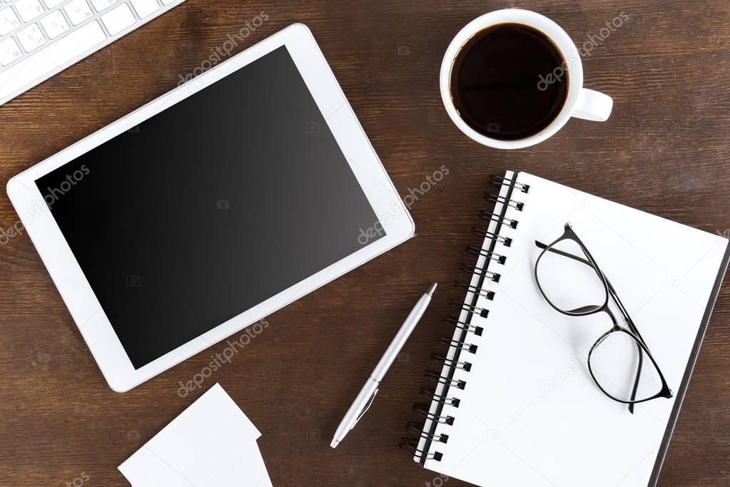 coffee cup and tablet on workplace