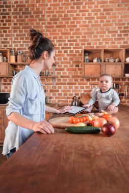 Mother with son in the kitchen clipart