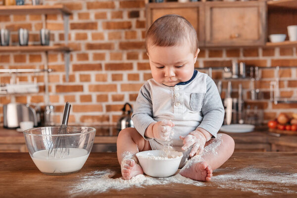 Little boy playing with flour