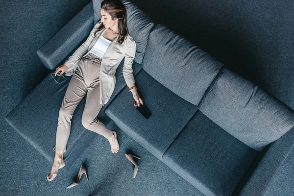 Tired businesswoman resting on couch — Stock Photo, Image