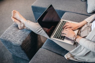 Woman typing on laptop clipart