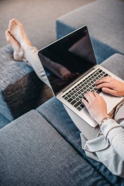 Woman typing on laptop clipart