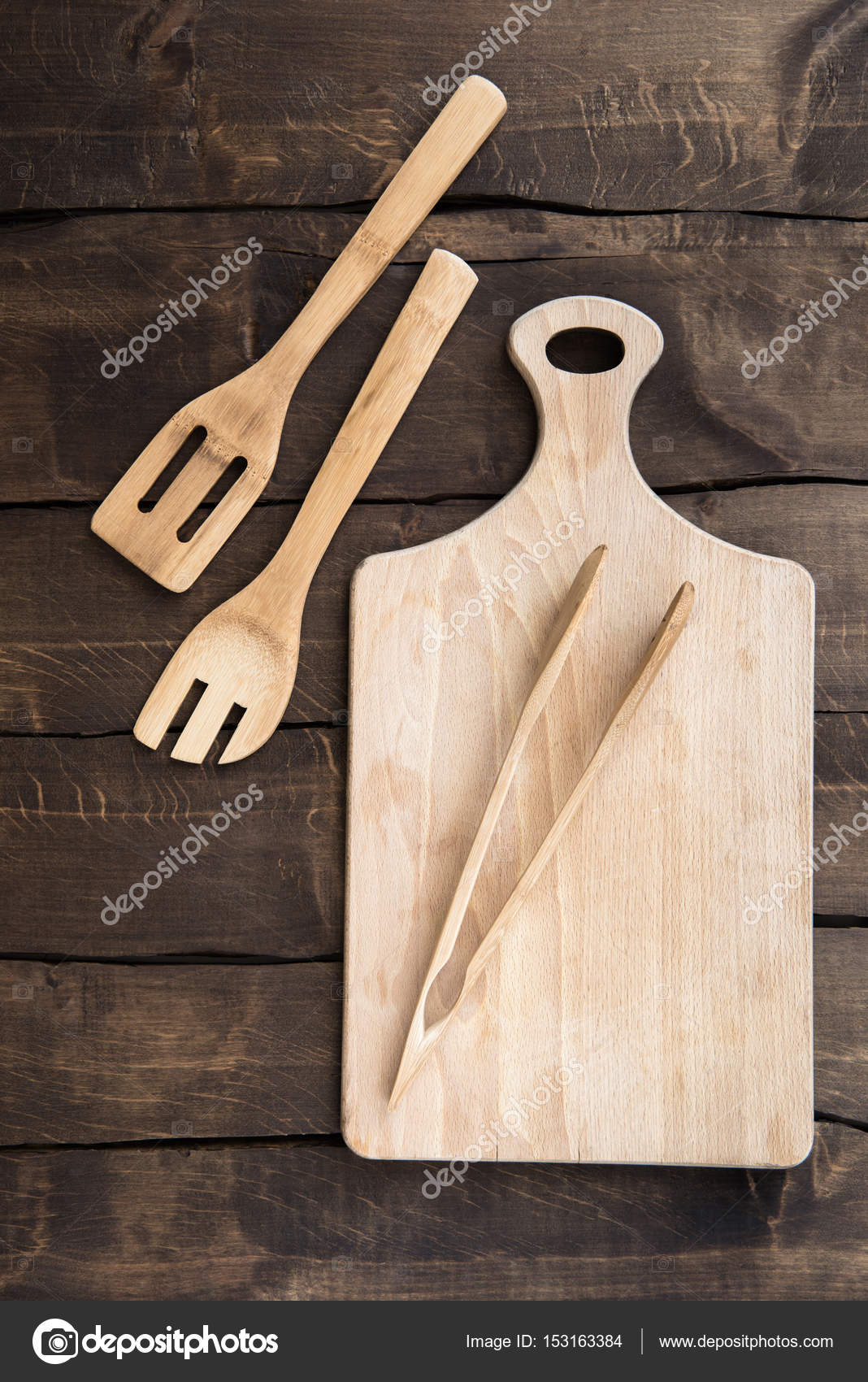 Chopping board with kitchen utensils Stock Photo by ©IgorTishenko 153163384