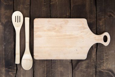 Chopping board with kitchen utensils