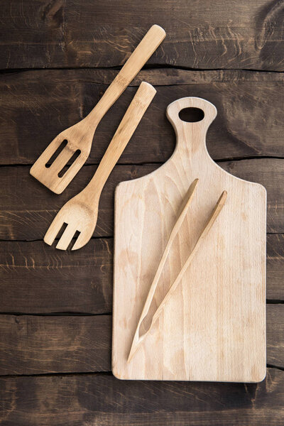 Chopping board with kitchen utensils