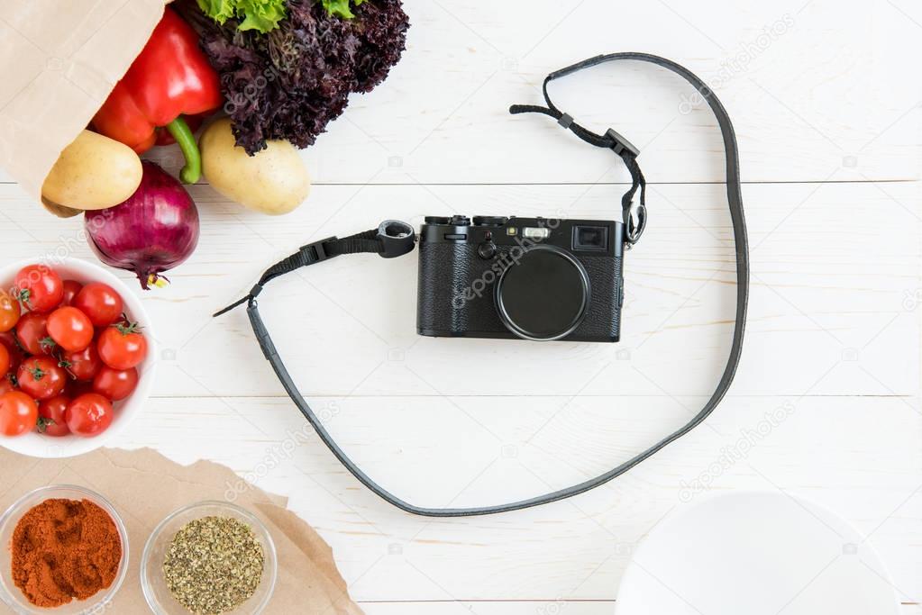 photo camera with vegetables and spices 