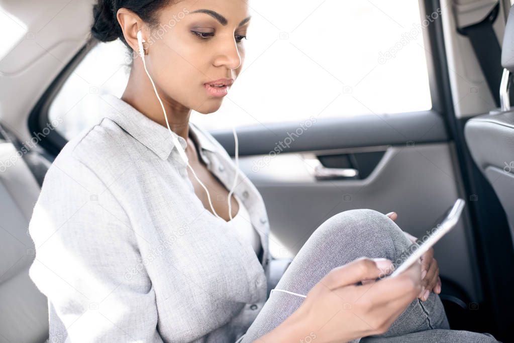 woman listening music in earphones