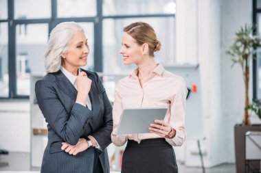 Businesswomen with digital tablet  clipart