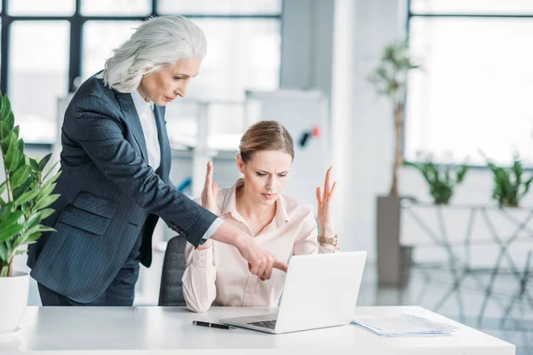 Businesswoman and her boss working with laptop — Stock Photo, Image