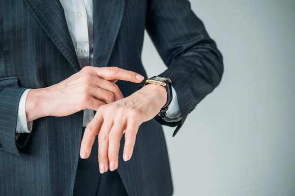 Businesswoman pointing at watch — Stock Photo, Image