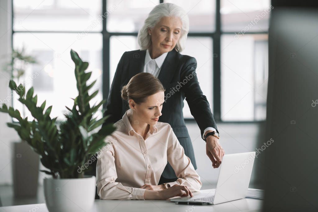 businesswoman and her boss working with laptop  