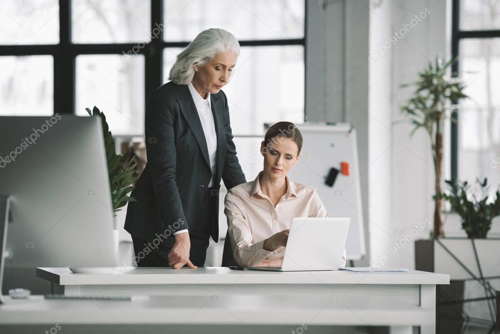 businesswoman and her boss working with laptop   