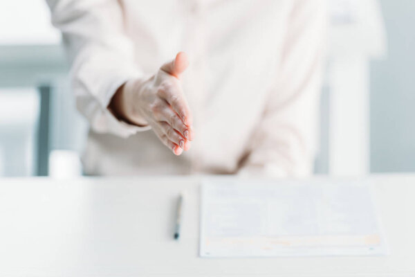 business woman with document on tabletop

