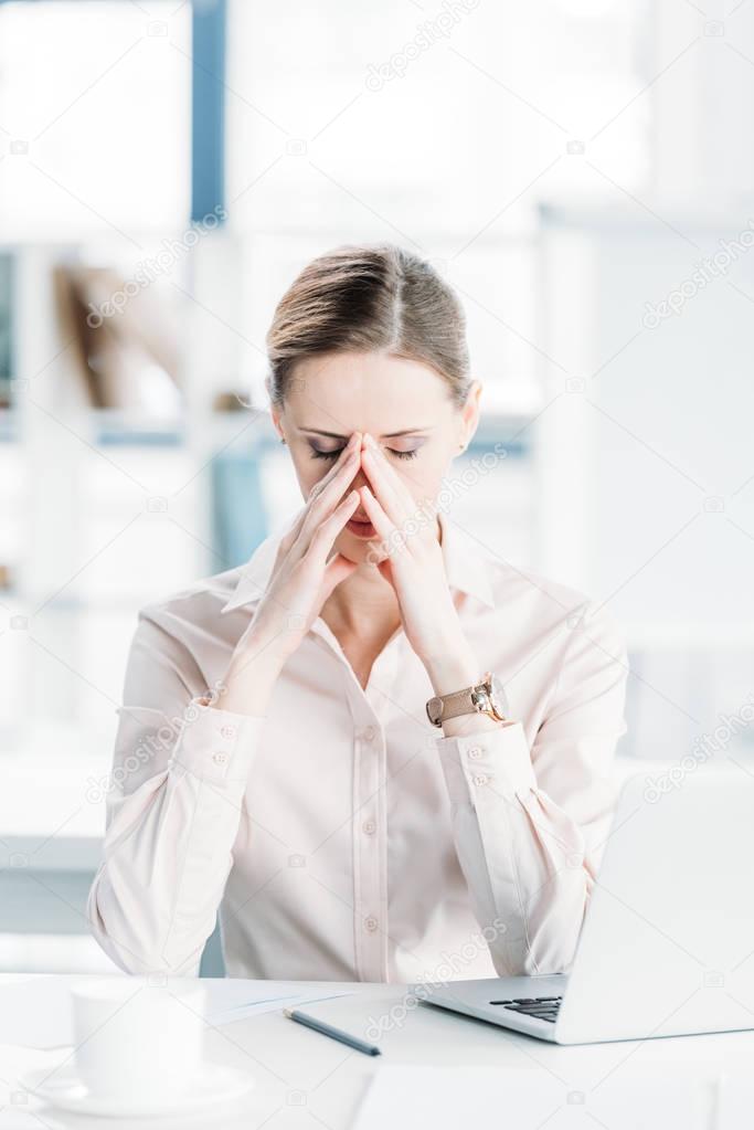 tired businesswoman at workplace