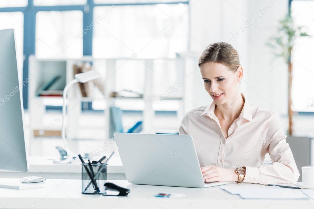 businesswoman working on laptop at office