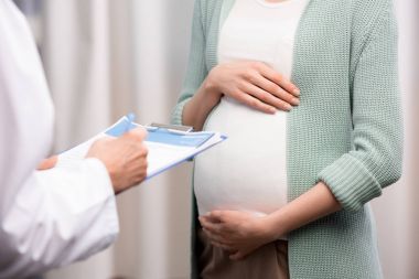 doctor with pregnant woman during consultation clipart