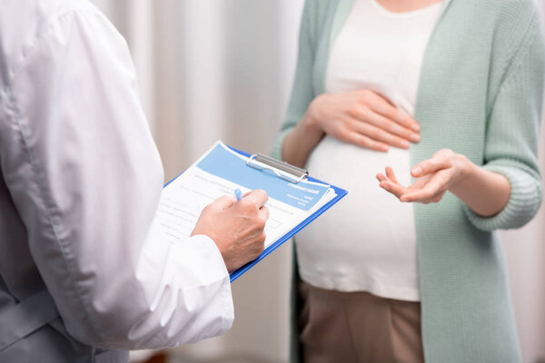 doctor with pregnant woman during consultation