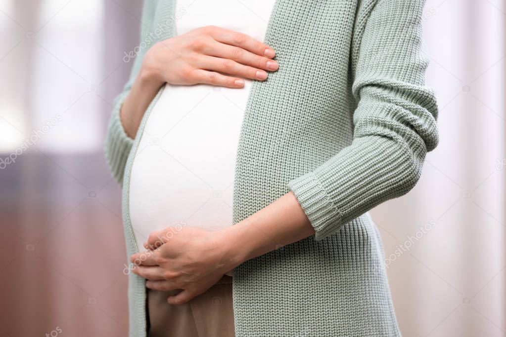 pregnant woman holding stomach