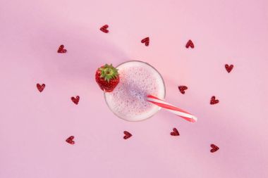 strawberry milkshake in glass with drinking straw clipart