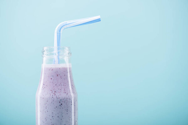 Tasty milkshake in glass bottle 