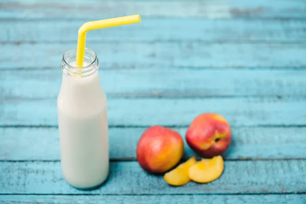 Tasty milkshake in glass bottle — Stock Photo, Image