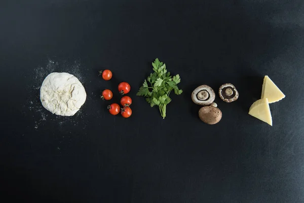 dough with ingredients for preparing pizza