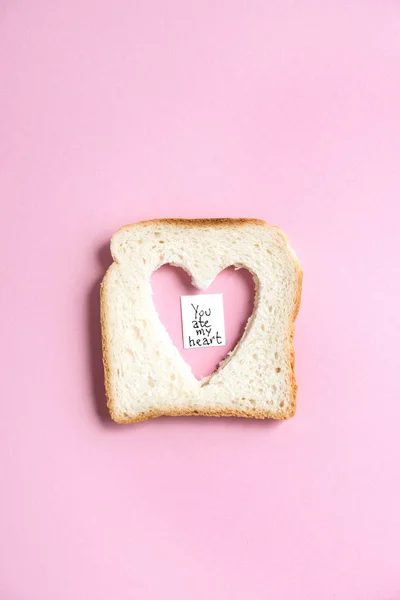 Toasted bread with heart shaped hole — Stock Photo, Image