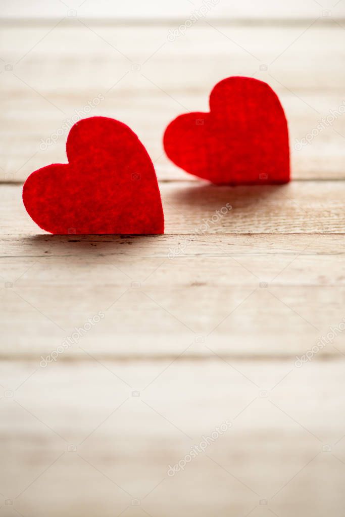 Red hearts lying on wooden table