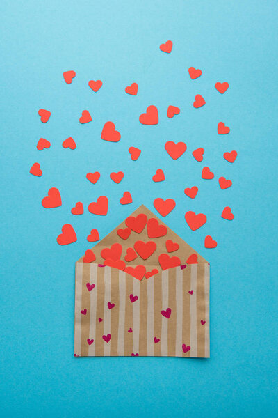 Open envelope with red hearts