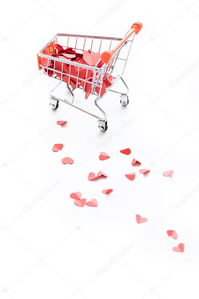 Shopping trolley full of red hearts
