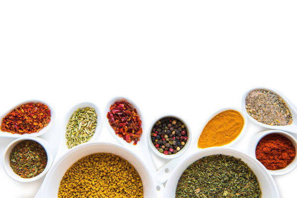 Spices in spoons and bowls 