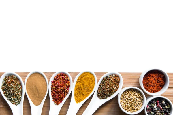 Spices and herbs in spoons snd bowles on tabletop — Stock Photo, Image