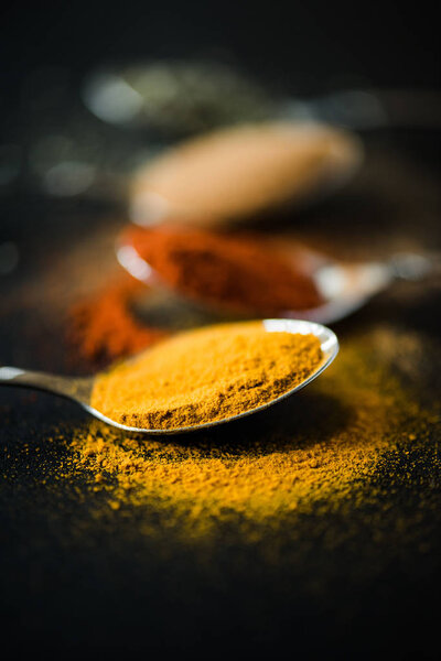 spices and herbs in metal spoon