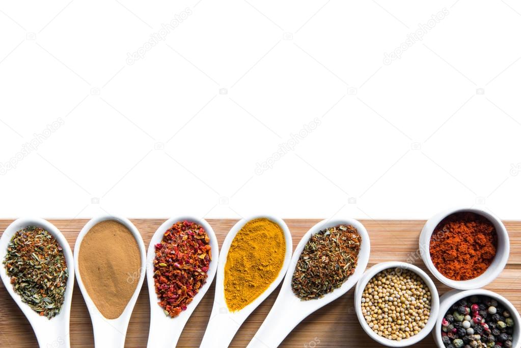 spices and herbs in spoons snd bowles on tabletop