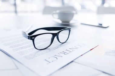 eyeglasses and business contract clipart