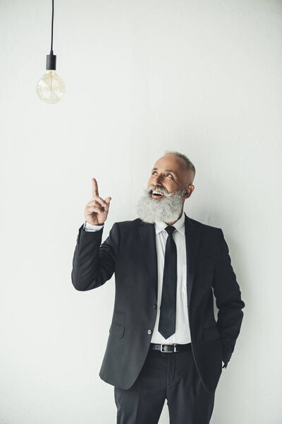businessman pointing at light bulb